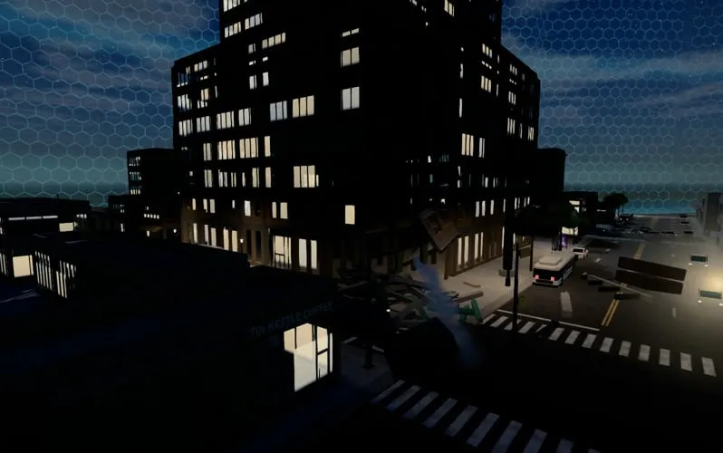 A city street at night from above: a tall office tower with lit windows, wreckage at its corner, a bus at the crossing and a warm streetlight beside it