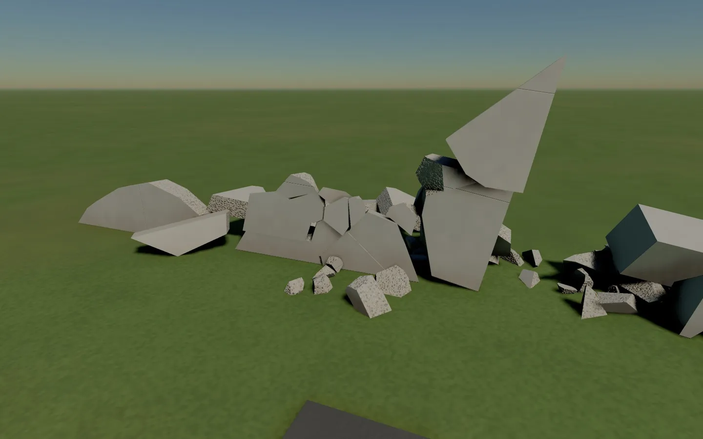 Broken concrete pieces from a collapse resting on the grass, September 29